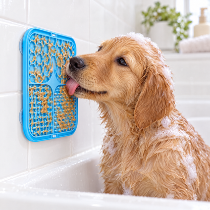 Blue silicone lick mat stuck to a bathtub wall, puppy licking it during a bath
